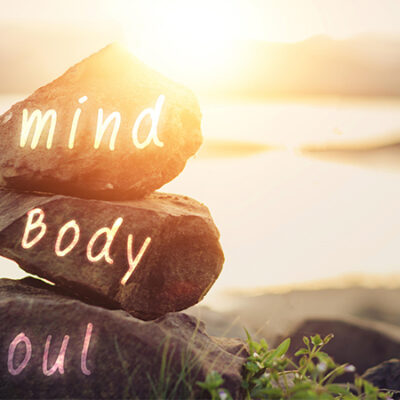 Spa concept of zen stones with deep red plumeria flower Word Mind body soul